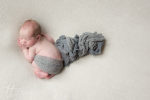 Sleeping newborn baby with flowing wrap