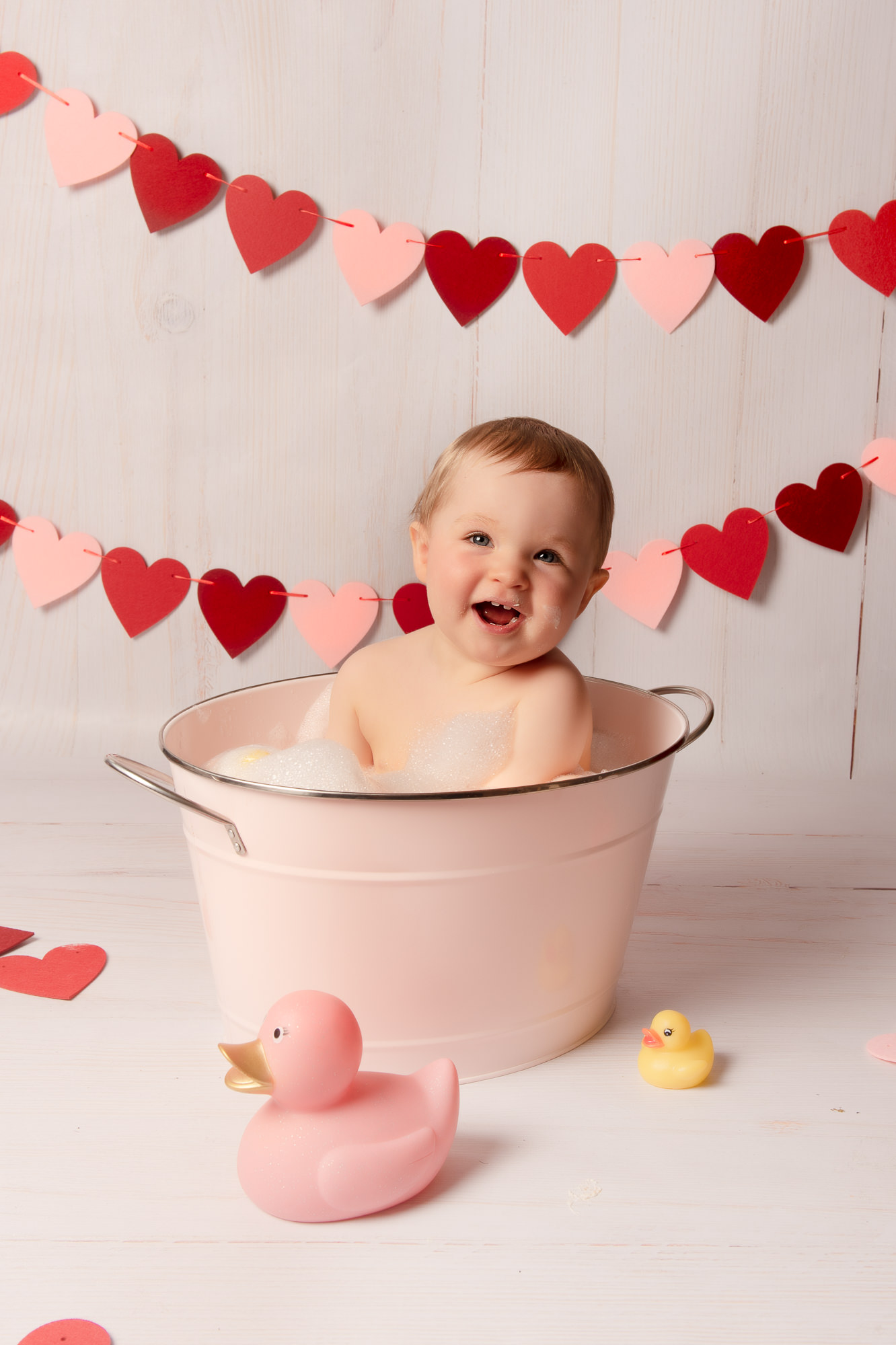Happy baby splashing in bath tub