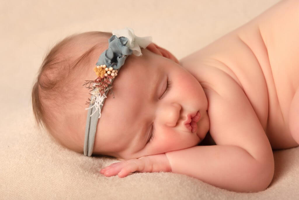 NEWBORN BABY GIRL WEARING FLORAL HALO