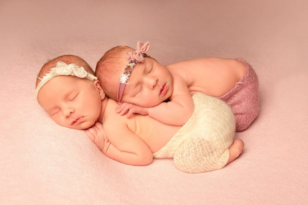Twin baby girls snuggled together
